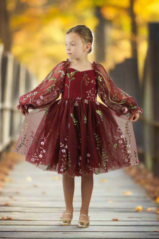 Flower girl dress in burgundy floral. Long tulle sleeves and knee length style dress.