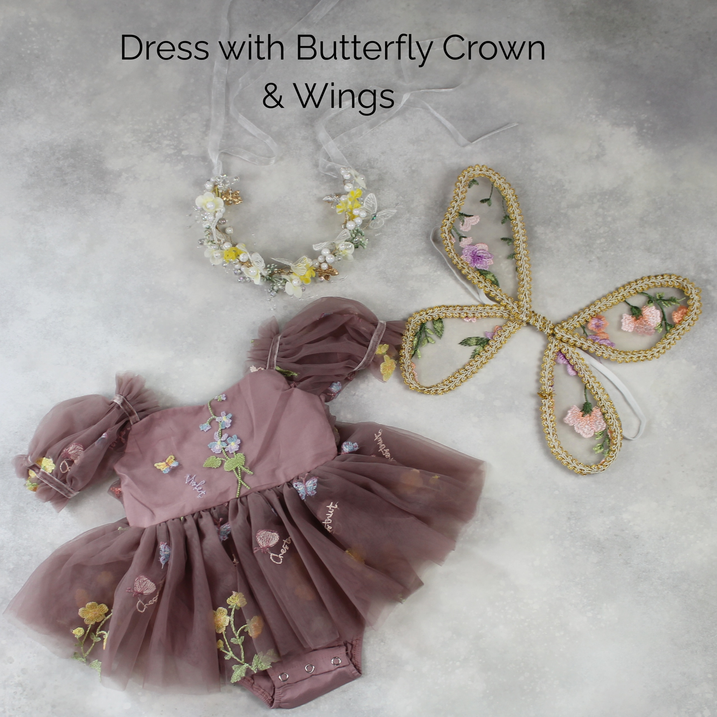 Baby Girl first birthday dress in dusty purple floral embroidery flowers for fairy and wildflower and fairy birthday parties. With Crown and wings