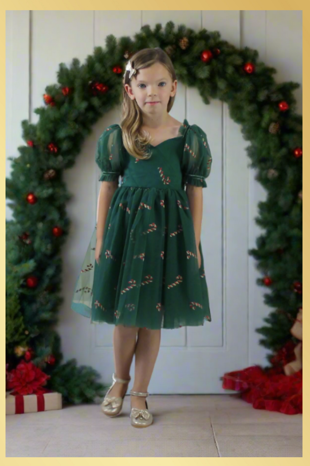 Girls Candy Cane Christmas Dress in green tulle with glitter candy cane pattern. Sweetheart neckline, short sleeves, and knee length style