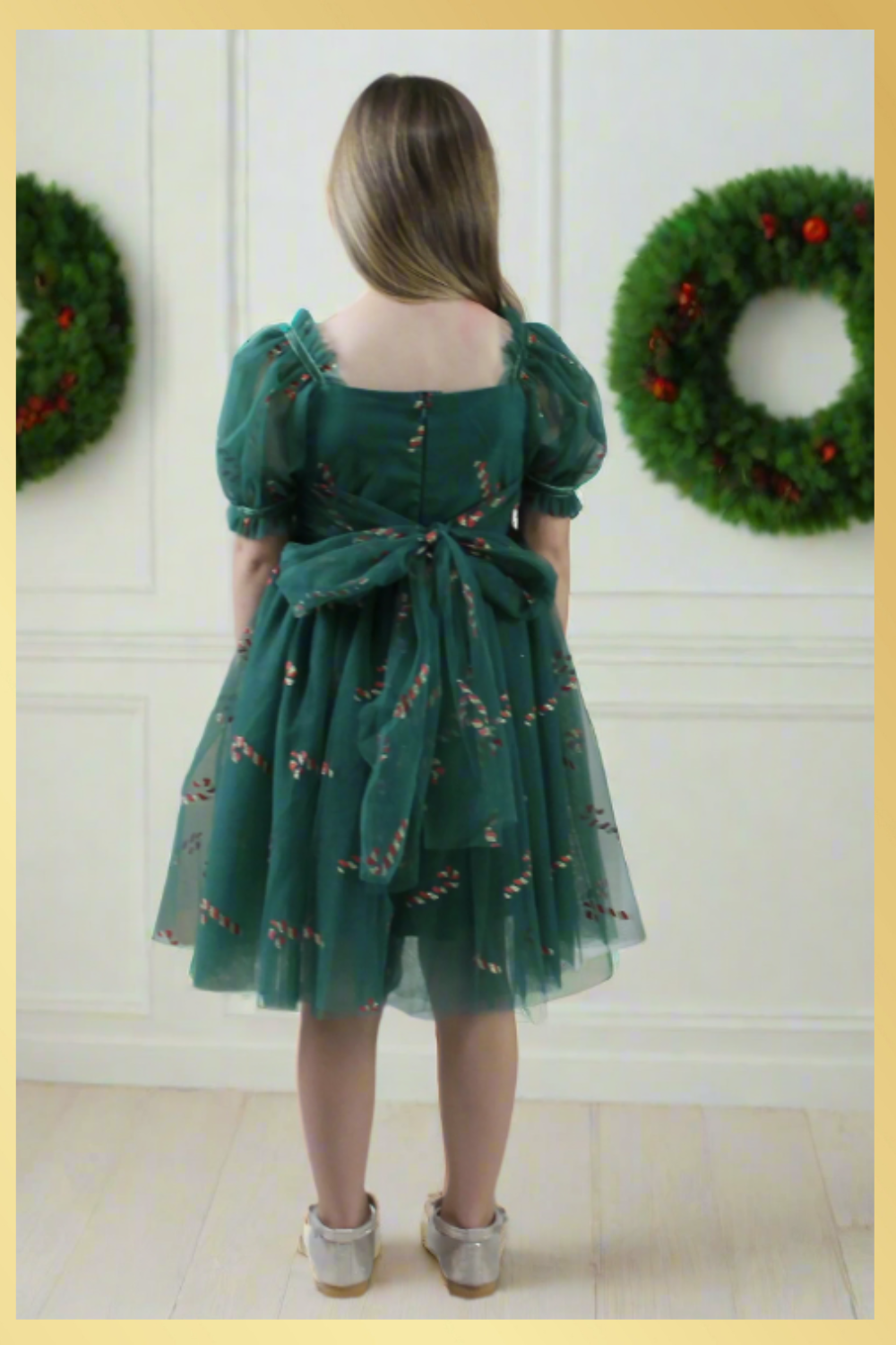 Girls Candy Cane Christmas Dress in green tulle with glitter candy cane pattern. Sweetheart neckline, short sleeves, and knee length style