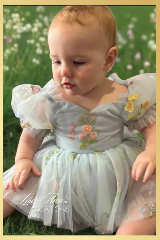 The perfect baby girl dress in light blue floral with a floral embroidery design. With a built in bodysuit to complete the dress.
