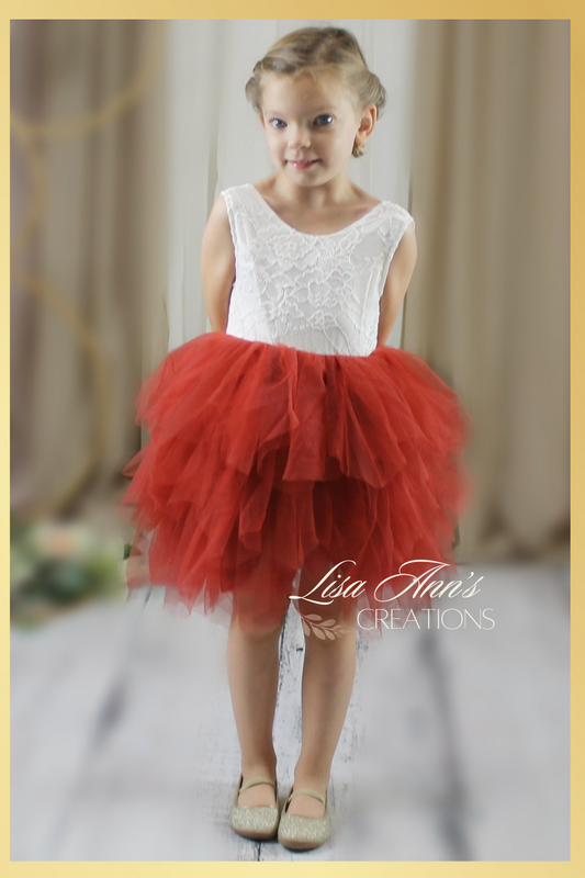 Flower girl dress in a rust tulle tiered skirt style. top bodice in a white lace sleeveless cut.