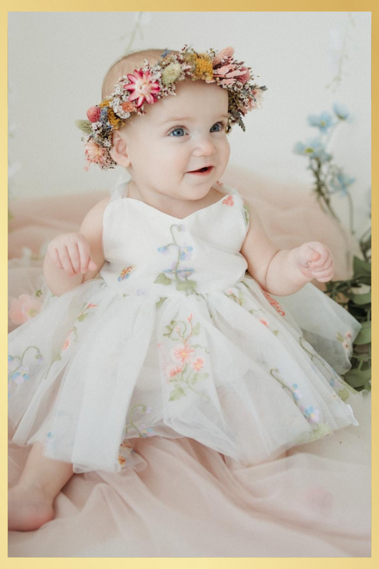 Baby girl first birthday fair dress in white florals.
