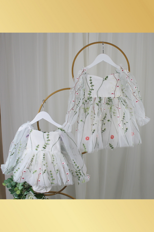 white floral flower girl dress for baby's, toddlers and little girls. made with long sheer sleeves a sweat heart neckline and knee length style for all your special occasions.
