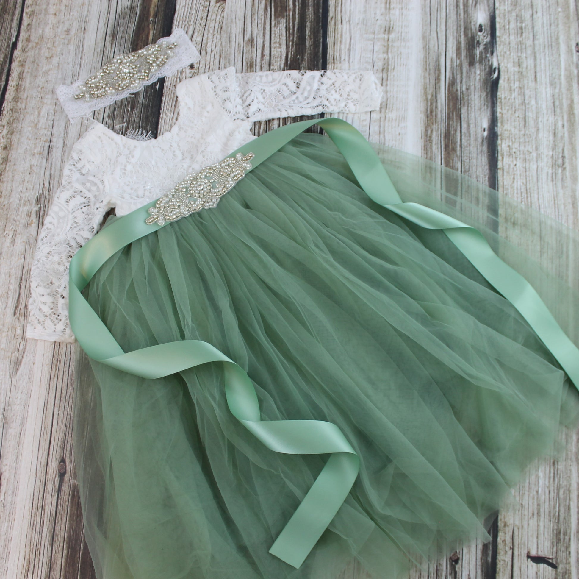 flower girl dress in sage green with rhinestone sash and headband