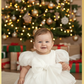 Baby Girls white Christmas romper dress for holiday parties and family photos. In a short puffy sleeve style with shiny organza material for a short midi thigh style