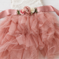 blush flower girl dress in a tiered sleeveless tutu style. In lace and tulle. 