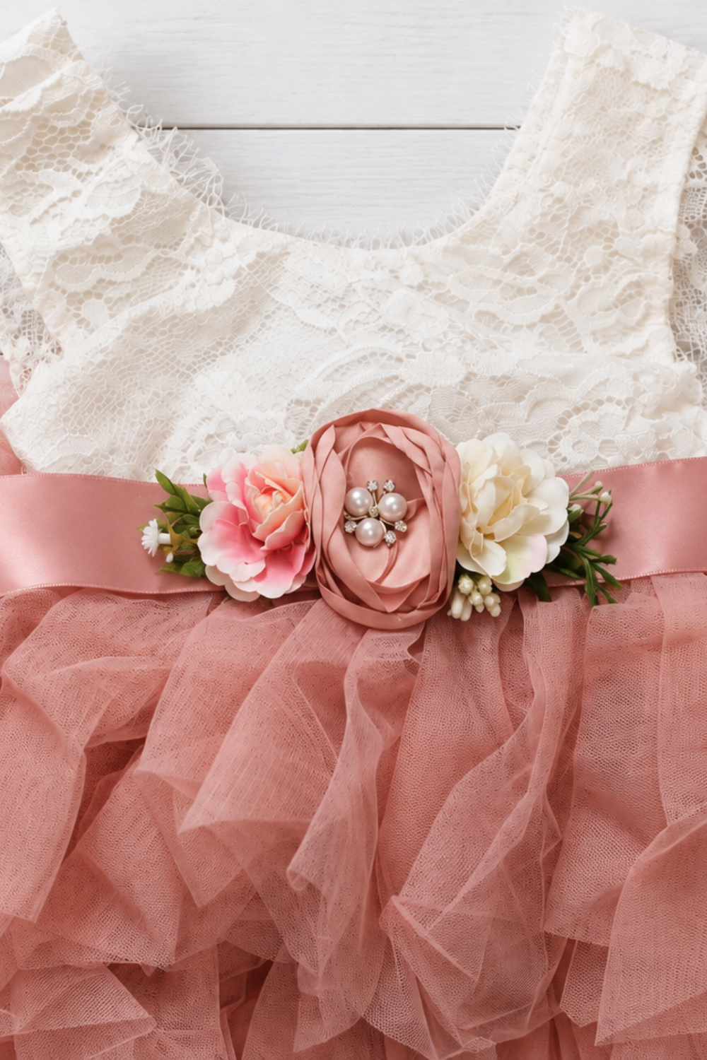 blush flower girl dress in a tiered sleeveless tutu style. In lace and tulle. 