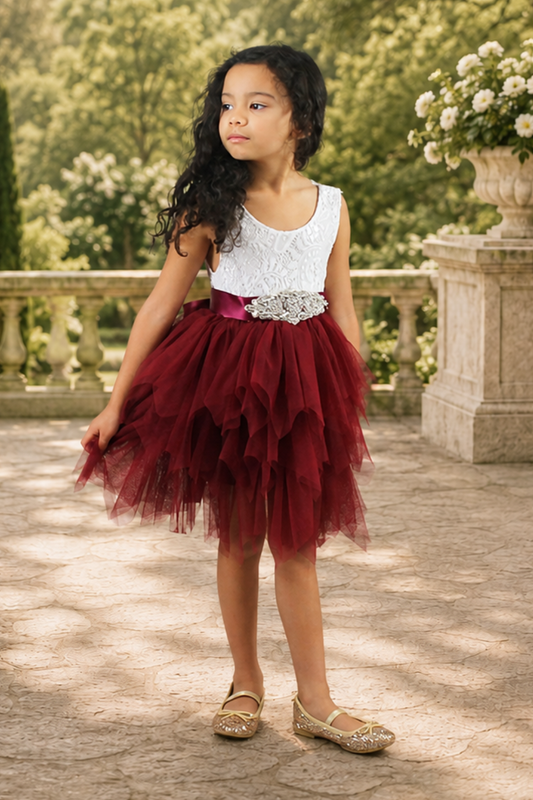 flower girl dress in a tiered tutu style. Burgundy knee length tulle and white sleeveless bodice. 