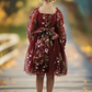 Burgundy floral long sleeve flower girl dress made in a knee length style. 