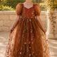 flower girl dress in burnt orange floral embroidered tulle. Featuring a sweat heart neckline, puffy short sleeves and a full length dress.