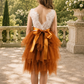 burnt orange flower girl dress in a tiered tulle tutu style with white sleeveless lace bodice. 