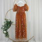 toddler flower girl dress in burnt orange floral embroidered tulle. Featuring a sweat heart neckline, puffy short sleeves and a full length dress.