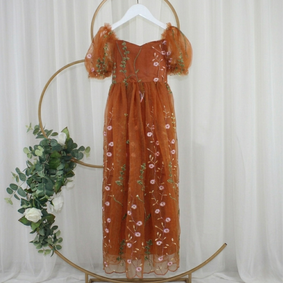 toddler flower girl dress in burnt orange floral embroidered tulle. Featuring a sweat heart neckline, puffy short sleeves and a full length dress.