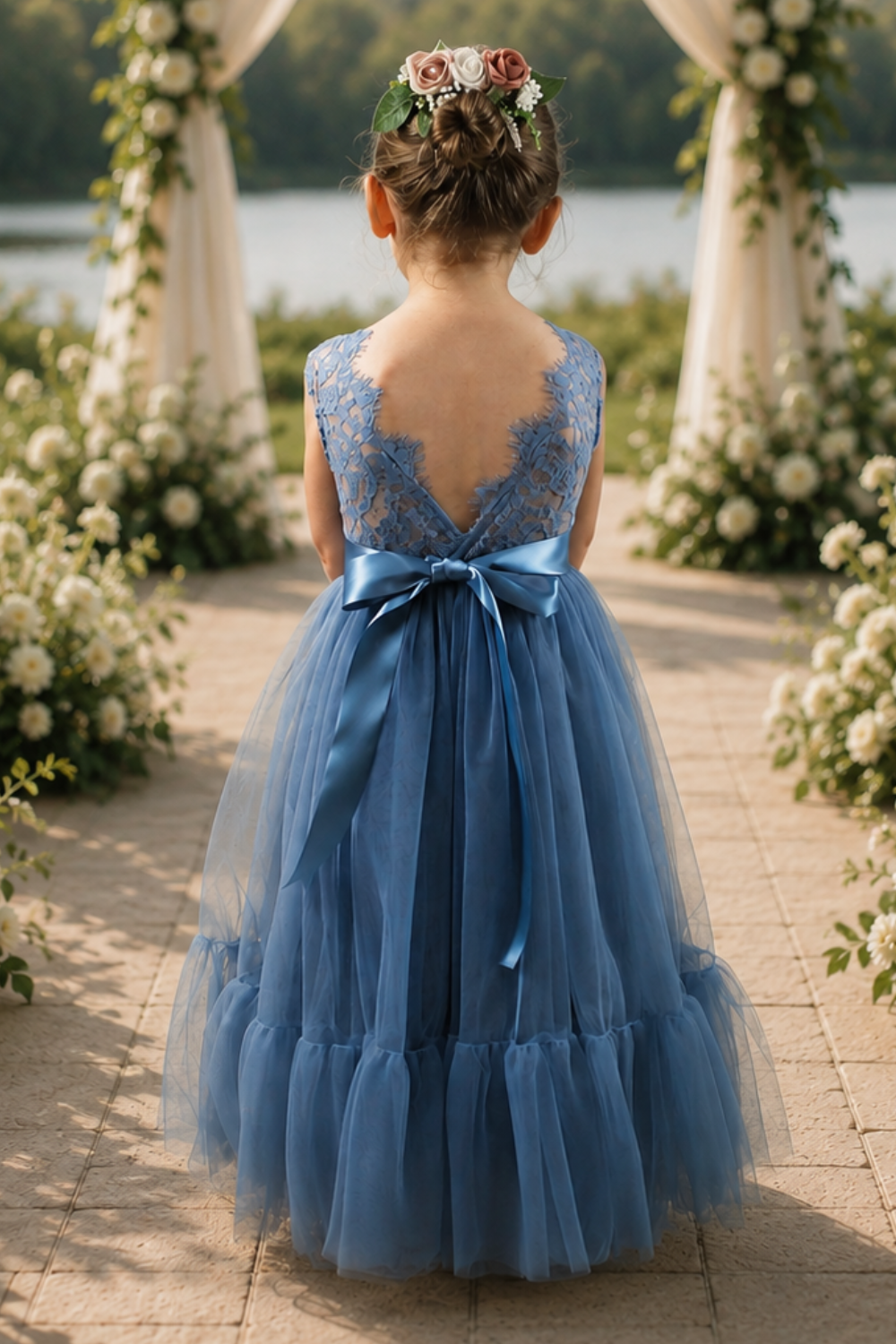 dusty blue flower girl dress in tulle and lace. With a mermaid flair bottom in full length.