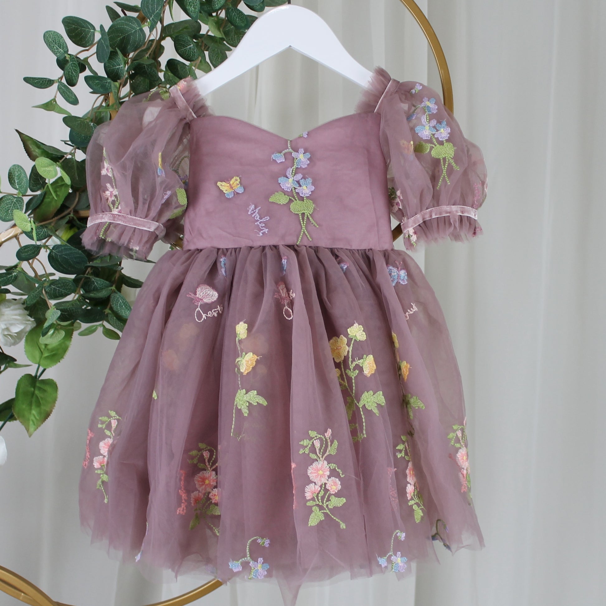 Baby Girl first birthday dress in dusty purple floral embroidery flowers for fairy and wildflower birthday parties. 