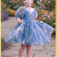floral dress in dusty blue tulle with embroidered flowers and butterflies all over the dress. In a puff sleeve and knee length style. Prefect for an upcoming wedding or birthday. 
