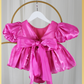 baby girl dress in fuchsia pink. Big puffy sleeves in romper style Organza shiny material. For first birthdays and flower girl dresses for weddings