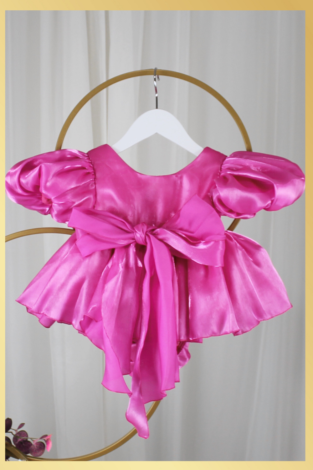 baby girl dress in fuchsia pink. Big puffy sleeves in romper style Organza shiny material. For first birthdays and flower girl dresses for weddings