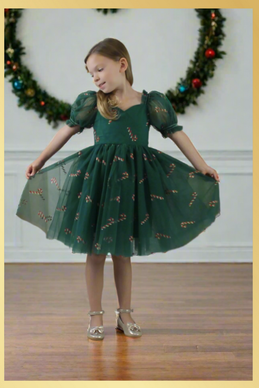 Girls Candy Cane Christmas Dress in green tulle with glitter candy cane pattern. Sweetheart neckline, short sleeves, and knee length style