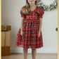 Girls red and green plaid Christmas dress in a short sleeve sweetheart neckline and knee length style. For holiday parties and family photos. 