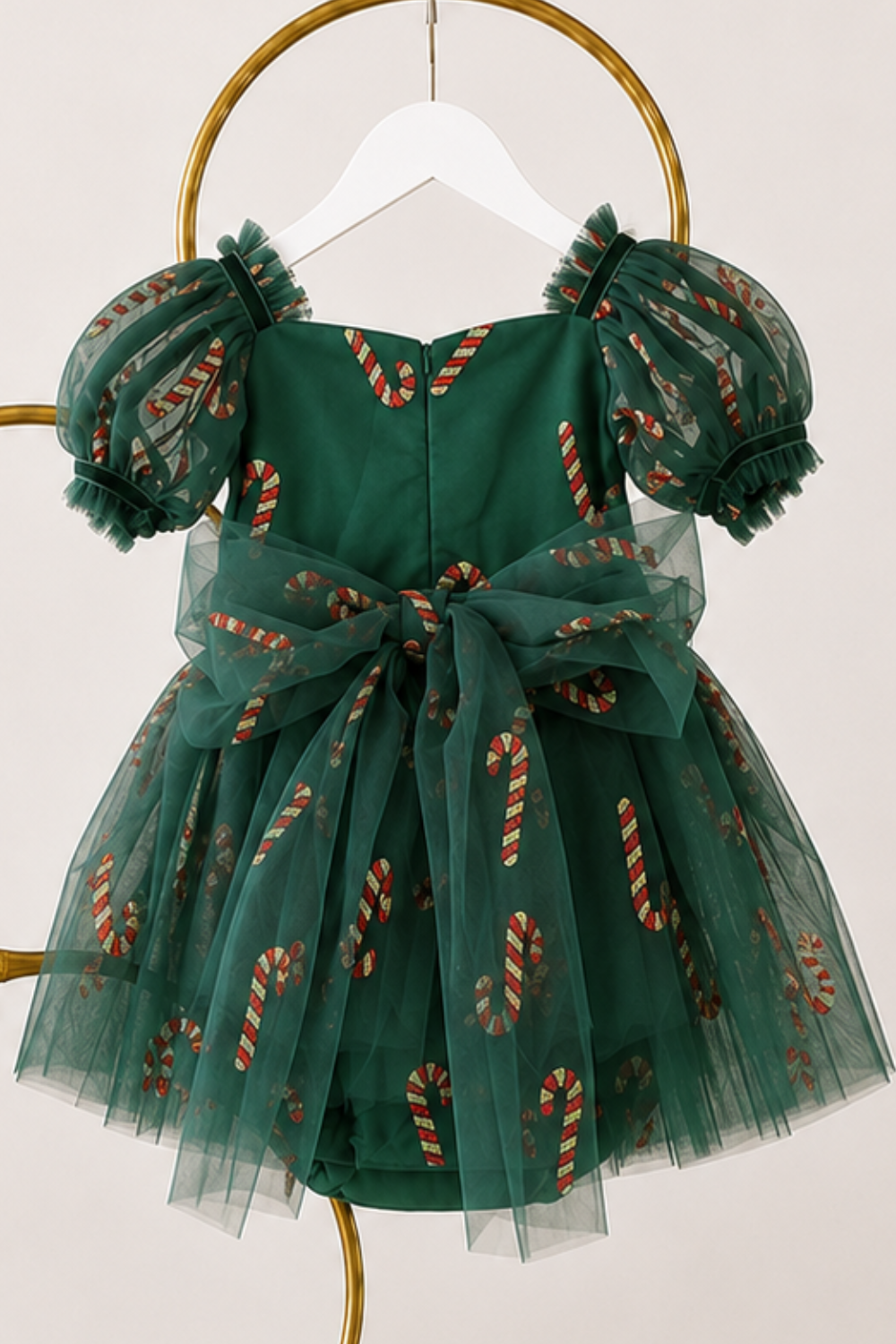 Christmas dress for baby featuring green candy cane tulle, sweetheart neckline, short puff sleeves and built-in bodysuit.