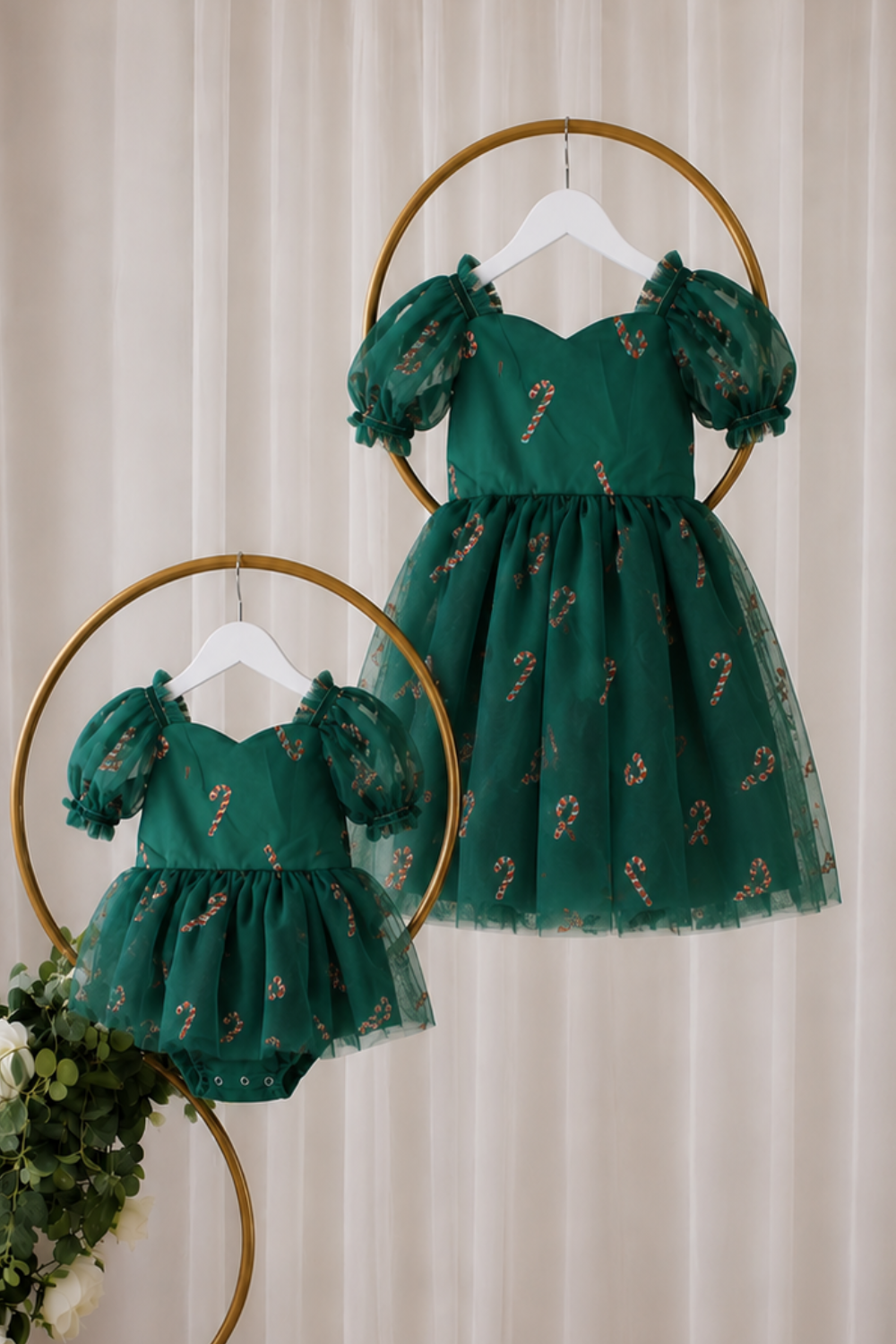 Baby dress for Christmas in green candy cane tulle with puff sleeves, sweetheart neckline and short bodysuit-style design.