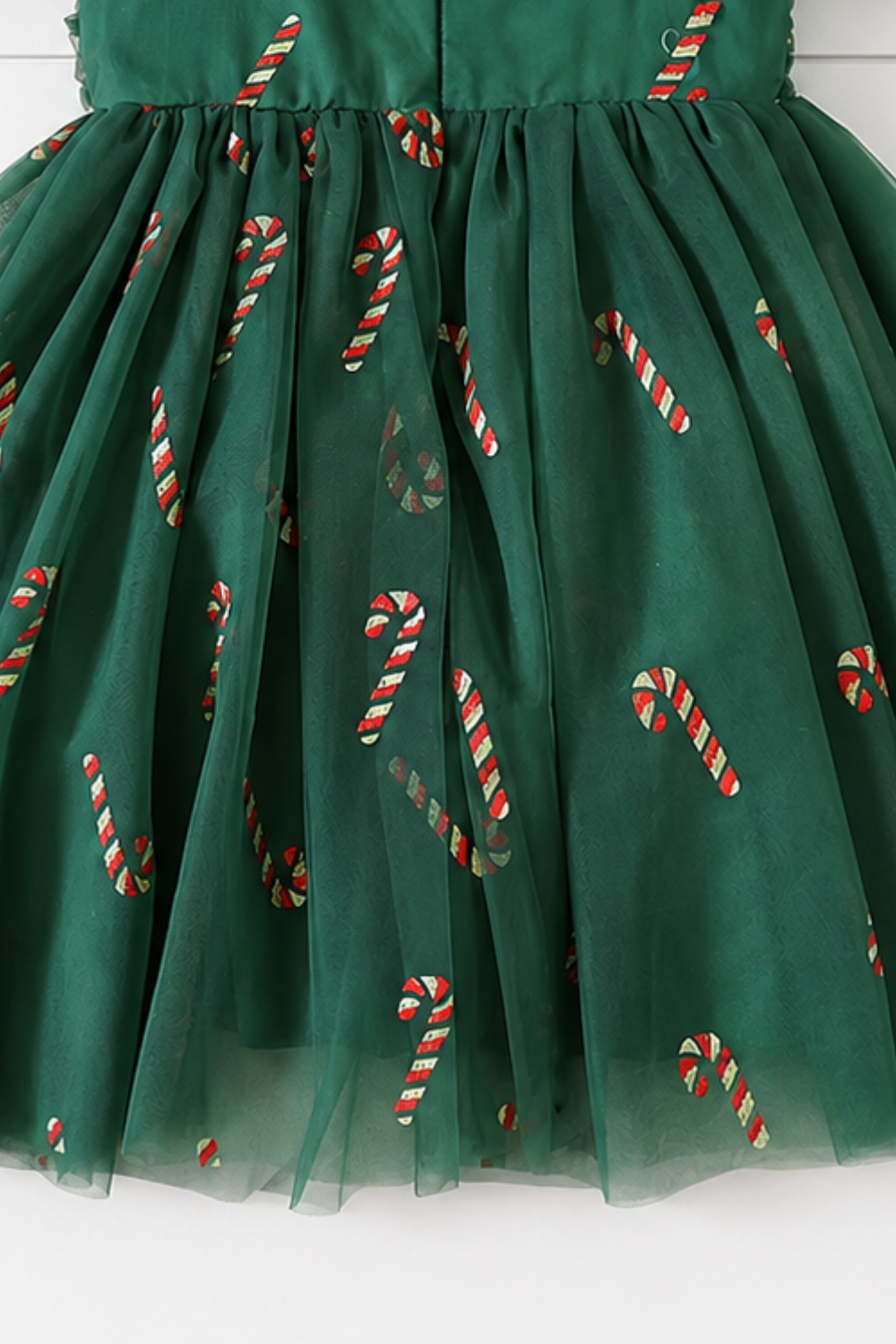Baby Christmas outfit with coordinating green candy cane tulle dresses available in baby, toddler and girls sizes.