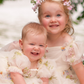 Floral flower girl dress in ivory tulle with puffy sleeves and bow