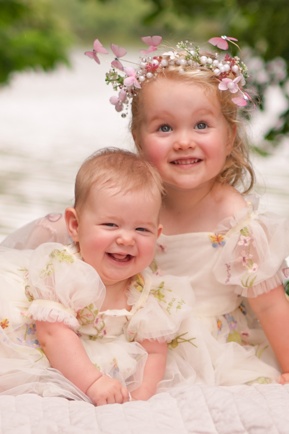 Floral flower girl dress in ivory tulle with puffy sleeves and bow