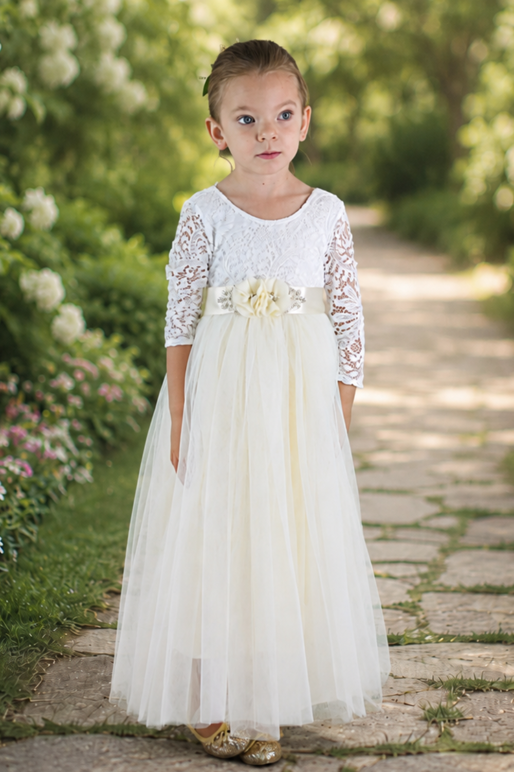 Tulle Flower Girl Dress in ivory with long lace sleeves and flowing full-length skirt for weddings