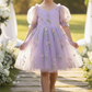 Floral flower girl dress in lavender tulle with puffy sleeves and big bow. 