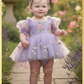 First birthday baby girl dress in lavender floral tulle with built in romper/bodysuit and puffy  short sleeves.