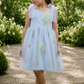 flower girl dress in light blue embroidered floral tulle in a knee length style dress. 