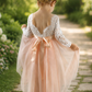 Flower girl dress in light peach tulle, long sleeve white lace and full length style.  