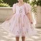 embroidered floral flower girl dress in light pink tulle with big puffy short sleeves and knee length style. 