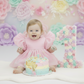 First Birthday light pink baby girl dress with puffy sleeves and big bow for birthdays and special occasions. 