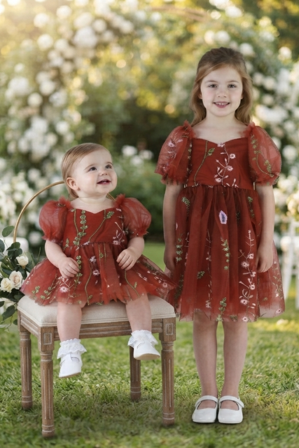 Flower girl dress in rust floral embroidery tulle with puffy sleeves and big bow. 
