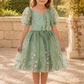 wildflower flower girl dress in a fall sage embroidered floral tulle with big puffy sleeves and a knee length style dress. 