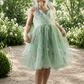 embroidered floral flower girl dress in sage green tulle in a sleeveless knee length style. 