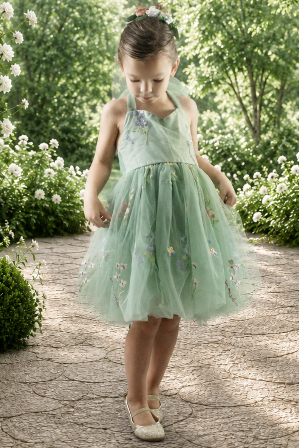 embroidered floral flower girl dress in sage green tulle in a sleeveless knee length style. 