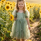Flower girl dress in sage floral for a spring summer or fall wedding. Made with tulle and puffy sleeves, and a big bow in back. 