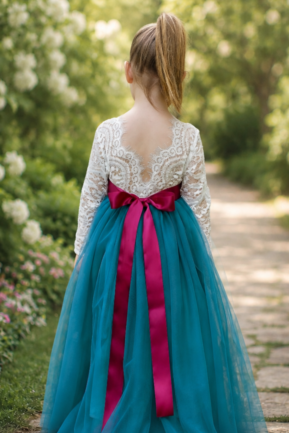 Tulle flower girl dress in teal with white lace bodice and full length skirt and v shaped back. 