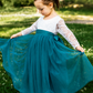 Lace flower girl dress with long sleeves and rich teal layered tulle skirt