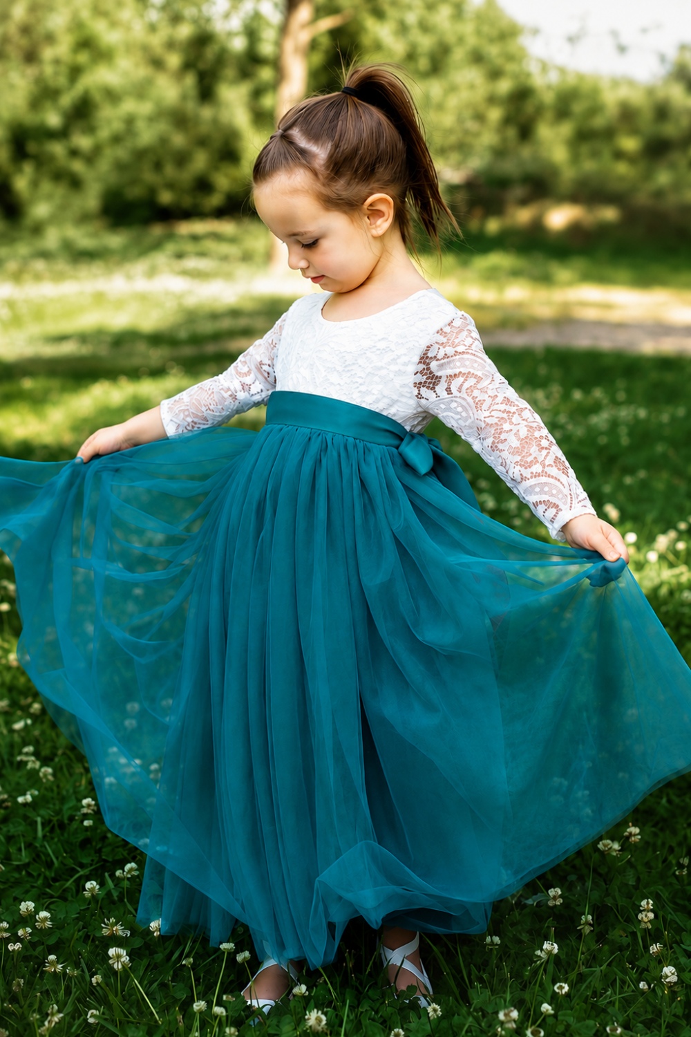Lace flower girl dress with long sleeves and rich teal layered tulle skirt