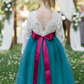 Flower girl dress in teal tulle with long lace white bodice. 