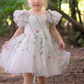 White floral girls and baby dress for flower girls, first birthdays and special occasions.  Sweetheart neckline, puffy sleeves, and knee length style in a fall floral tulle dress.