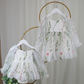 white floral flower girl dress for baby's, toddlers and little girls. made with long sheer sleeves a sweat heart neckline and knee length style for all your special occasions.