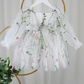 white floral flower girl dress for baby's, toddlers and little girls. made with long sheer sleeves a sweat heart neckline and knee length style for all your special occasions.