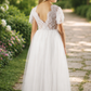 White flower girl dress in tulle and lace short sleeves and full length style.